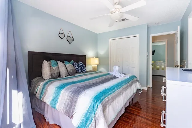 a bedroom with a bed and glass door