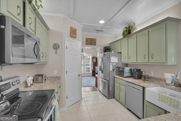 a kitchen with a refrigerator and a sink