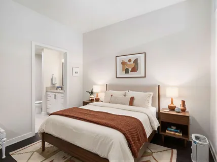 a bedroom with a bed and a wall painting