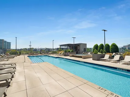 a view of a swimming pool with outdoor seating