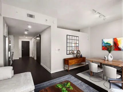 a living room with furniture fireplace and rug