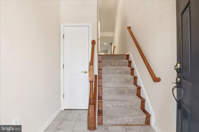 a view of a hallway with a sink and entryway