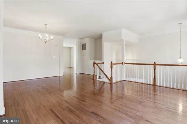 a kitchen with stainless steel appliances a sink a stove a refrigerator cabinets and a window