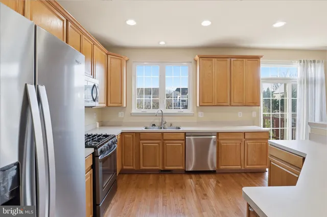 a view of a kitchen with wooden floor and a window