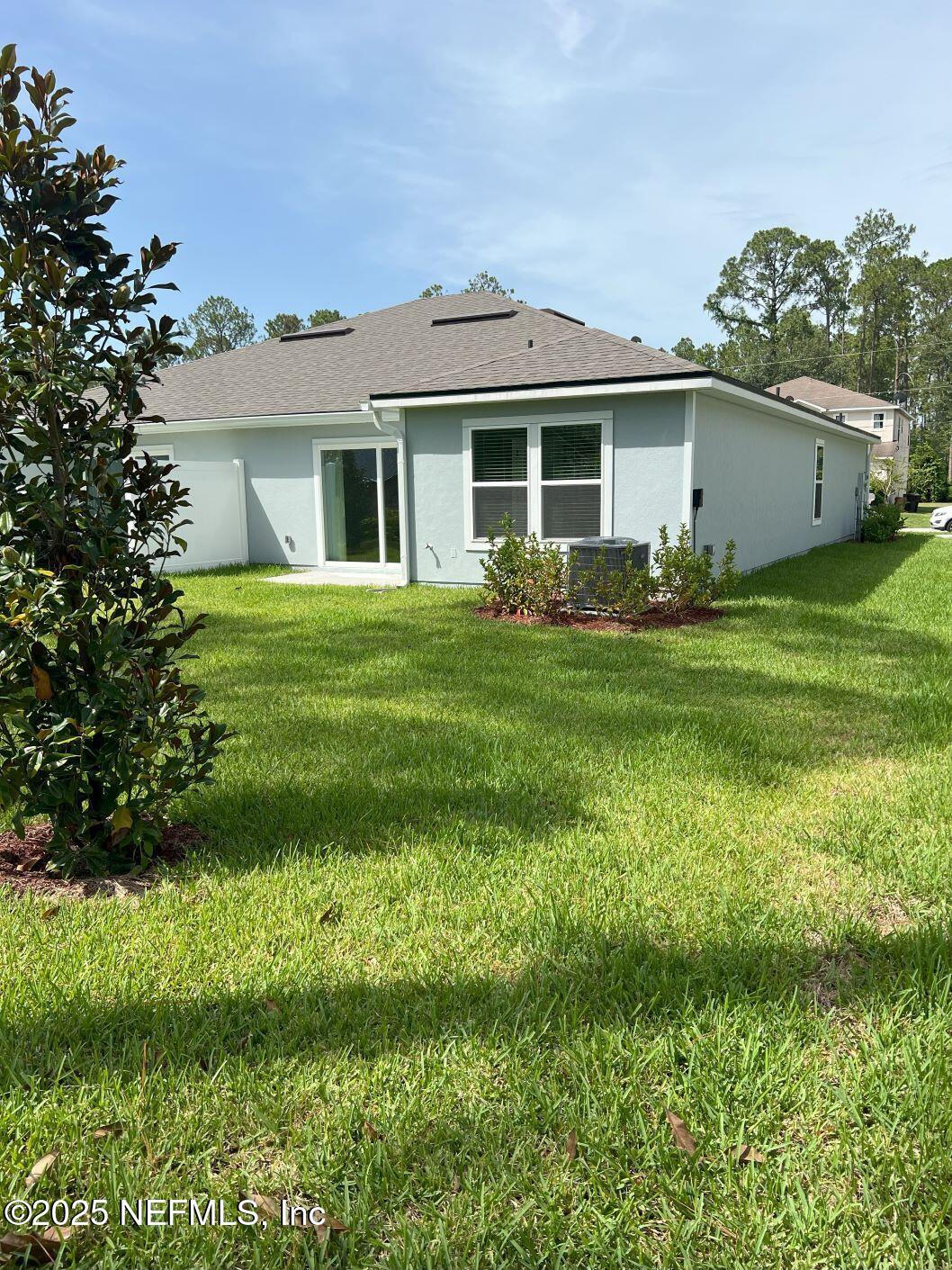 7 Ryall Lane, Unit B Palm Coast, FL 32164 - Photo 25 of 34 a view of a house with a backyard