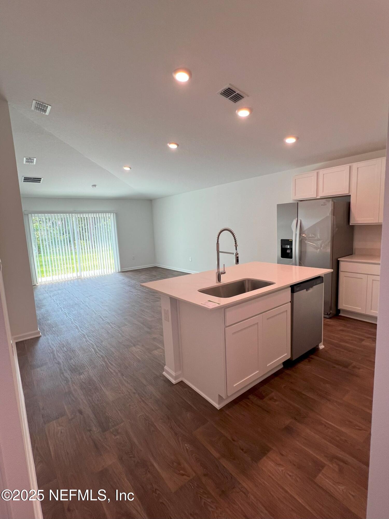 7 Ryall Lane, Unit B Palm Coast, FL 32164 - Photo 6 of 34 a kitchen with a sink and wooden floor