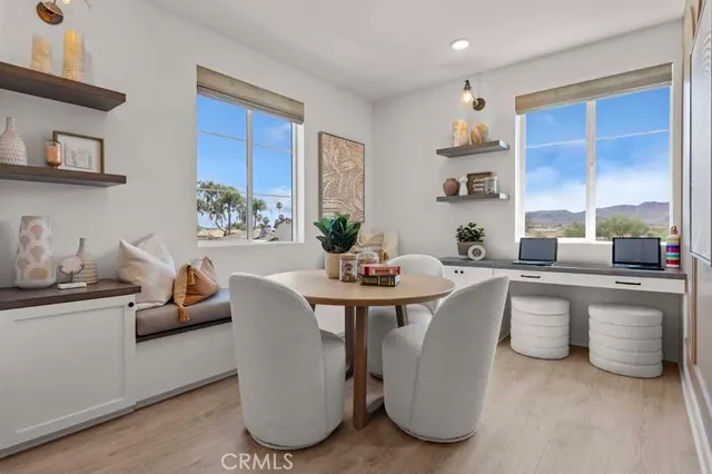 a very nice looking living room with a large window and white couches