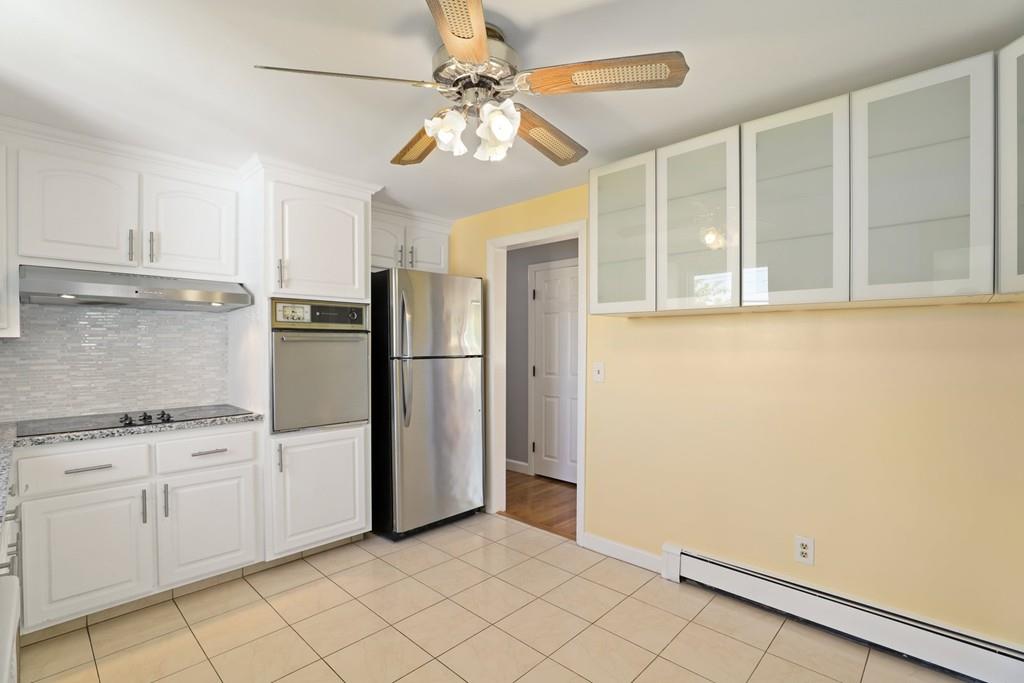 8 David Road Needham, MA 02494 - Photo 12 of 35 a view of a kitchen with white cabinets and refrigerator