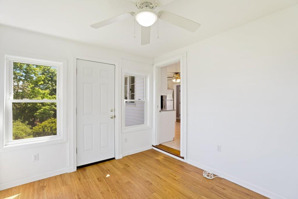 8 David Road Needham, MA 02494 - Photo 16 of 35 a view of an empty room with window and wooden floor