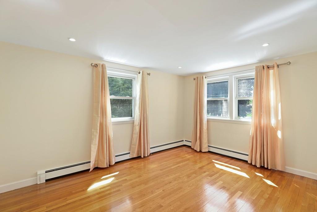 8 David Road Needham, MA 02494 - Photo 19 of 35 an empty room with wooden floor and windows