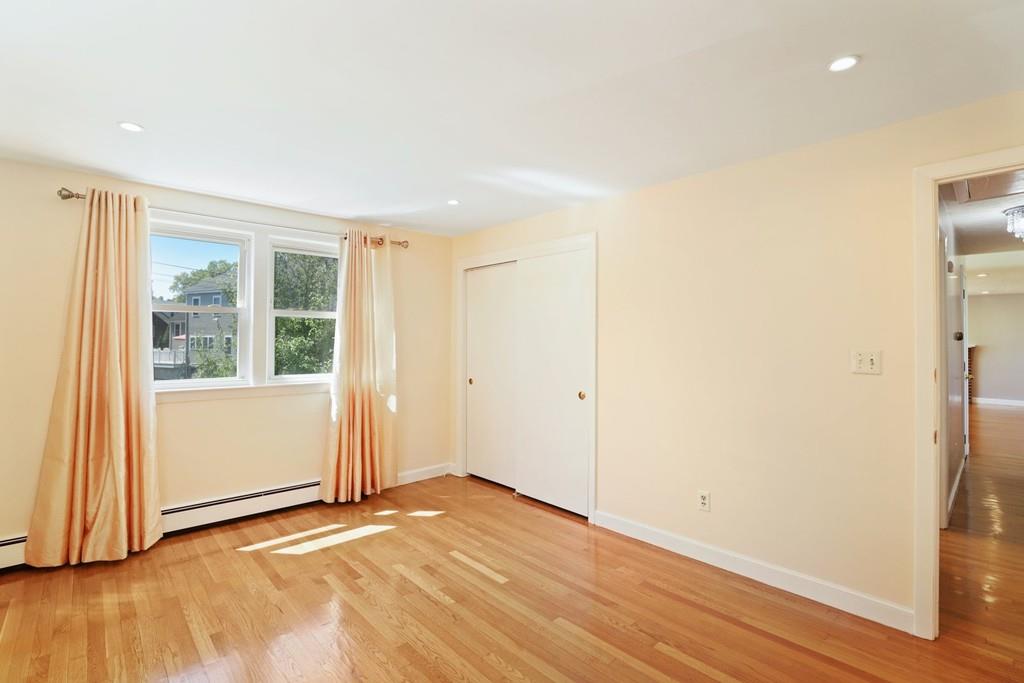 8 David Road Needham, MA 02494 - Photo 20 of 35 an empty room with wooden floor and windows