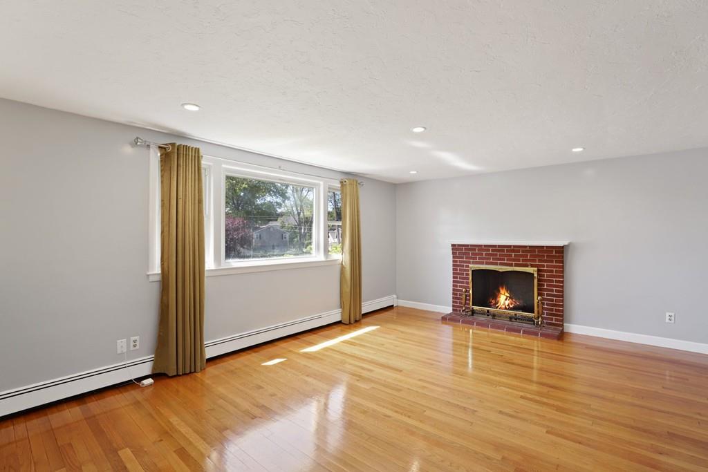8 David Road Needham, MA 02494 - Photo 5 of 35 a view of an empty room with window and fire place