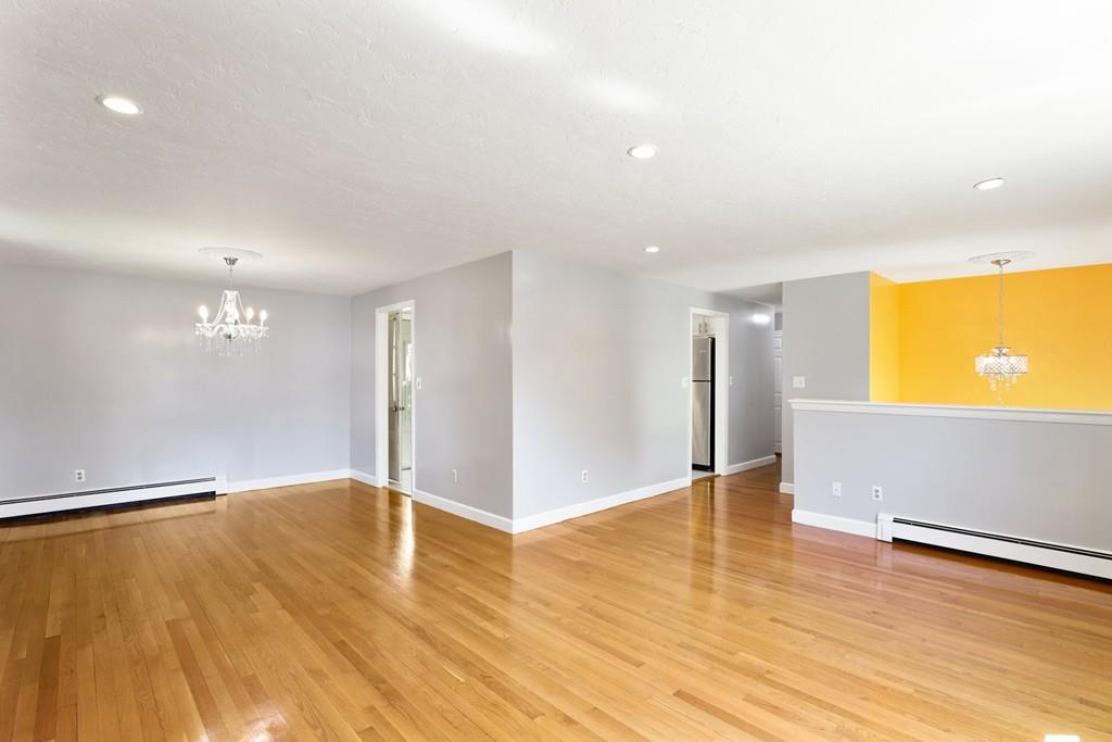 8 David Road Needham, MA 02494 - Photo 6 of 35 a view of an empty room with wooden floor and a window