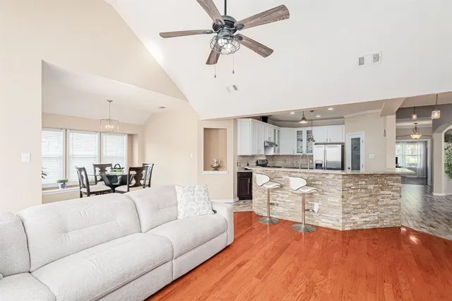 a kitchen with stainless steel appliances granite countertop a sink stove and cabinets