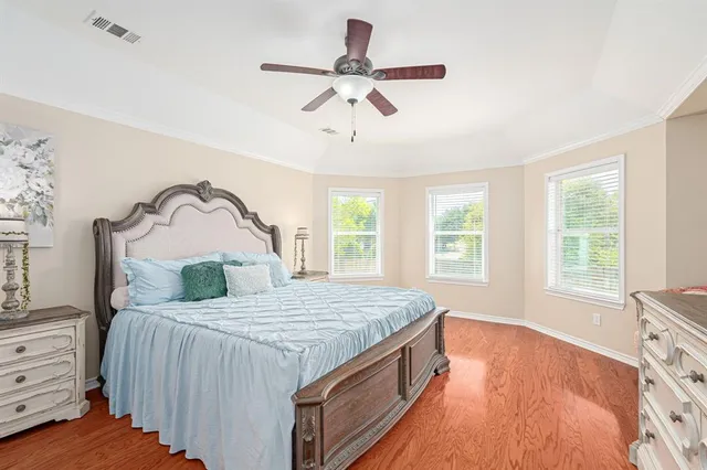 a bedroom with a bed and ceiling fan