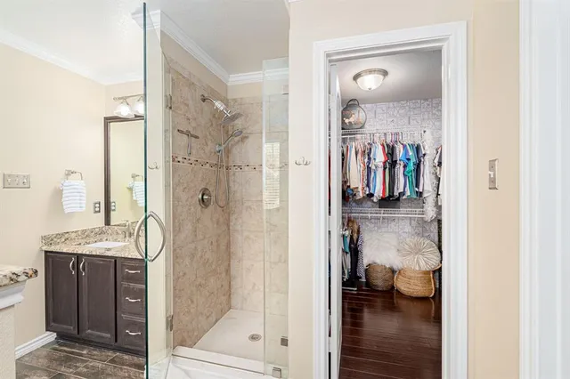 a view of walk in closet with clothes