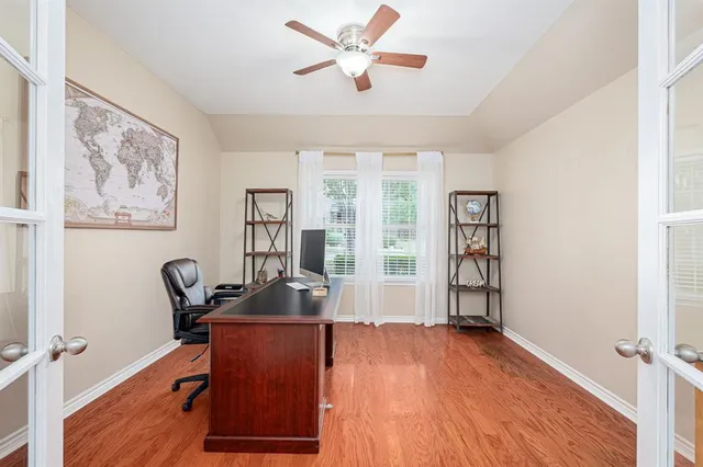 a view of a big room with wooden floor windows and cabinet