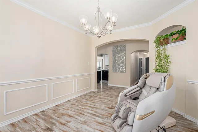 a living room with furniture a fireplace and a large window