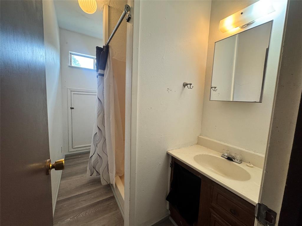 2605 West Azalea Drive Tyler, TX 75701 - Photo 17 of 25 a bathroom with a sink and mirror