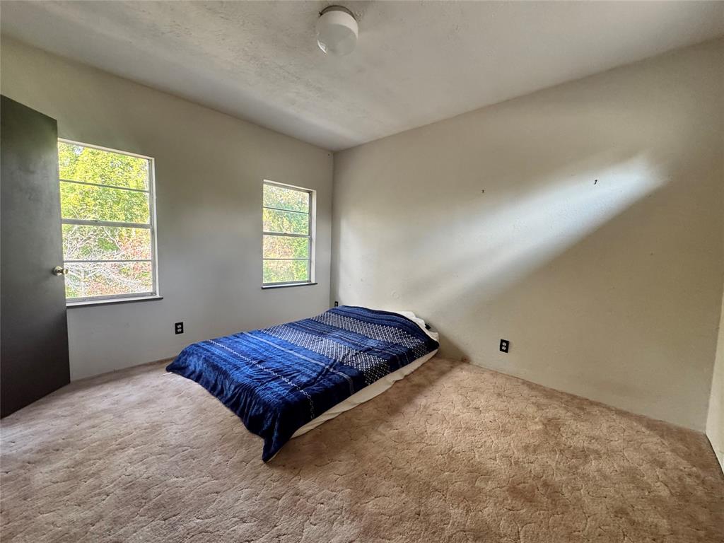 2605 West Azalea Drive Tyler, TX 75701 - Photo 18 of 25 a spacious bedroom with a bed and window