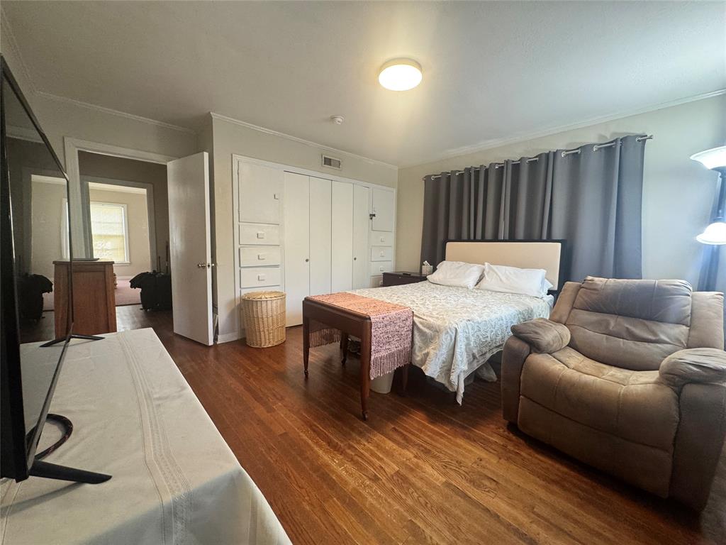 2605 West Azalea Drive Tyler, TX 75701 - Photo 6 of 25 a bedroom with furniture and wooden floor