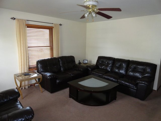 102 Roy Avenue Rochelle, IL 61068 - Photo 3 of 11 a living room with furniture and a window