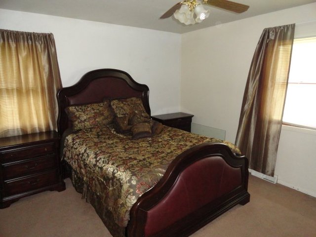 102 Roy Avenue Rochelle, IL 61068 - Photo 4 of 11 a bed sitting in a bedroom next to a window