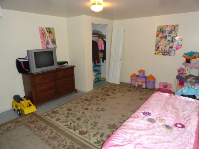 102 Roy Avenue Rochelle, IL 61068 - Photo 10 of 11 a bedroom with a bed and a couch