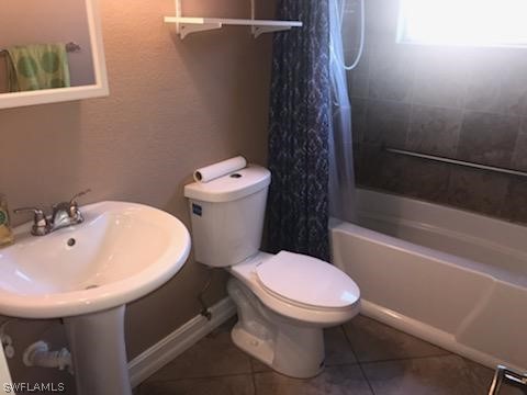 12419 River Road Fort Myers, FL 33905 - Photo 3 of 19 a white toilet sitting next to a bathroom sink and tub