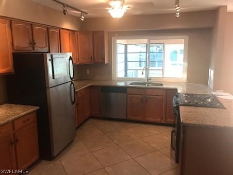 12419 River Road Fort Myers, FL 33905 - Photo 5 of 19 a kitchen with granite countertop a refrigerator and a sink
