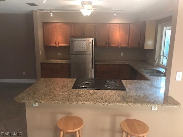 12419 River Road Fort Myers, FL 33905 - Photo 6 of 19 a kitchen with a refrigerator and a sink
