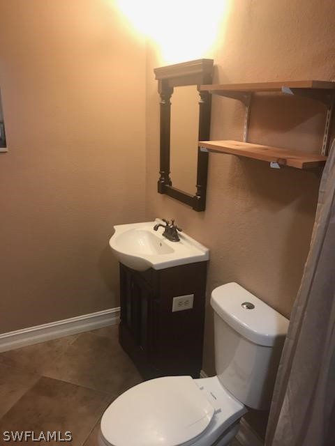12419 River Road Fort Myers, FL 33905 - Photo 8 of 19 a bathroom with a sink a toilet and mirror