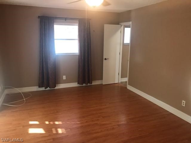 12419 River Road Fort Myers, FL 33905 - Photo 9 of 19 an empty room with wooden floor and windows