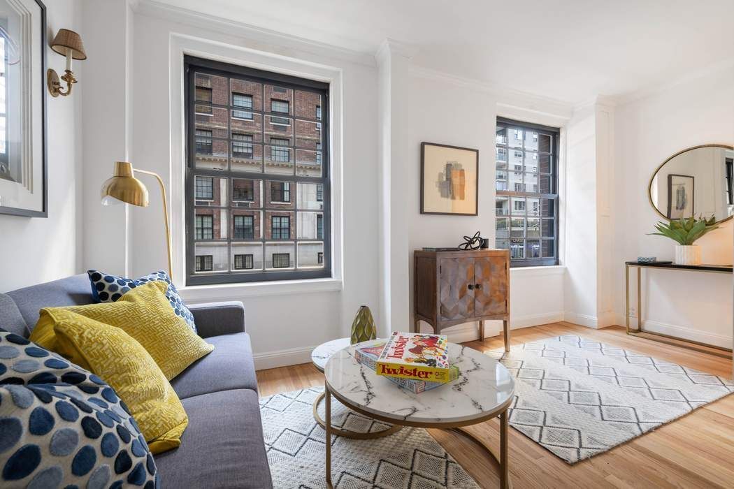 129 East 69th Street, Unit 2/3A Manhattan, NY 10021 - Photo 10 of 12 a living room with furniture and wooden floor