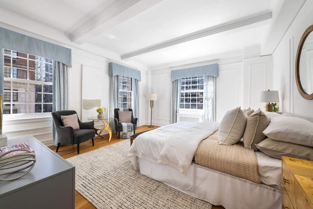129 East 69th Street, Unit 2/3A Manhattan, NY 10021 - Photo 6 of 12 a bedroom with a bed and wooden floor
