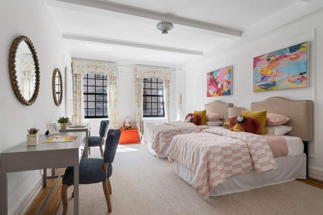 129 East 69th Street, Unit 2/3A Manhattan, NY 10021 - Photo 7 of 12 a bedroom with bed and a dining table with chairs