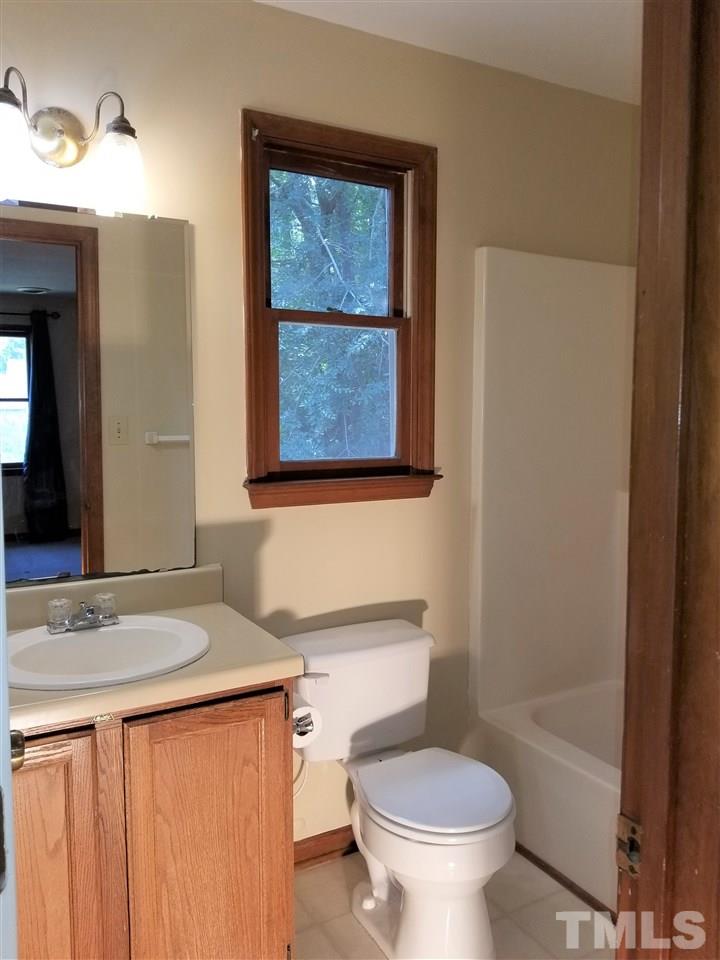 4524 Draper Road Raleigh, NC 27616 - Photo 12 of 20 a bathroom with a granite countertop sink toilet and large mirror