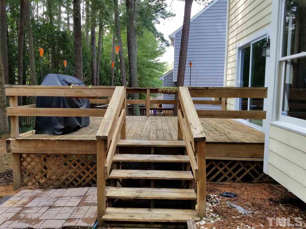 4524 Draper Road Raleigh, NC 27616 - Photo 18 of 20 a view of a patio with table and chairs with wooden floor and fence