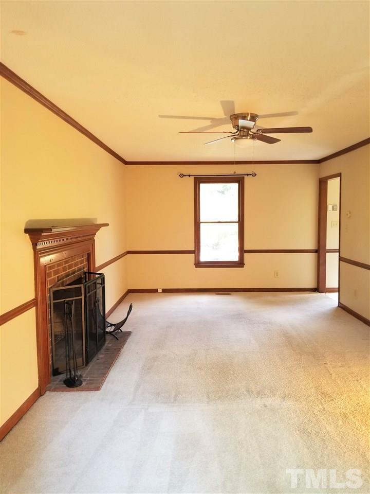 4524 Draper Road Raleigh, NC 27616 - Photo 2 of 20 a view of an empty room with a fireplace