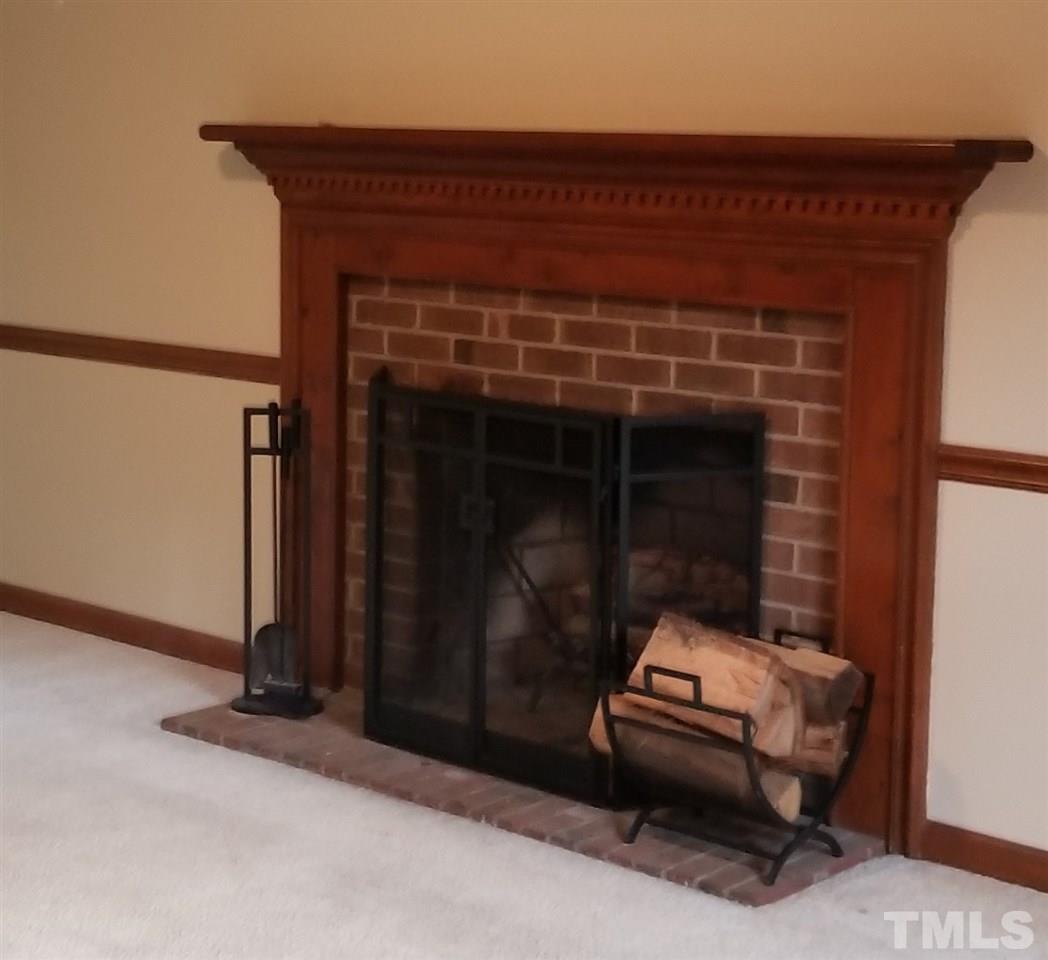 4524 Draper Road Raleigh, NC 27616 - Photo 3 of 20 a room with a couch and a fireplace