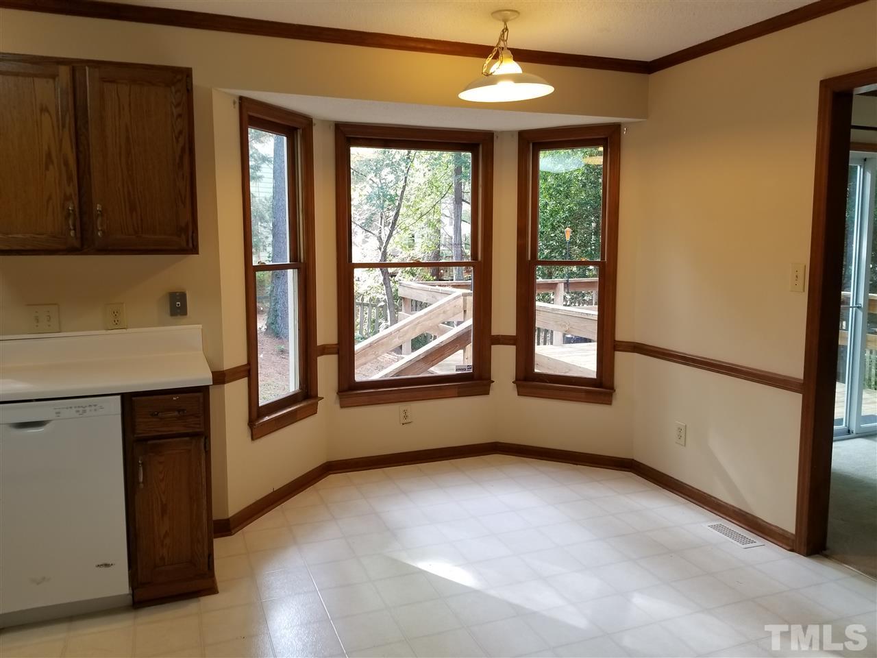 4524 Draper Road Raleigh, NC 27616 - Photo 6 of 20 an empty room with windows and chandelier