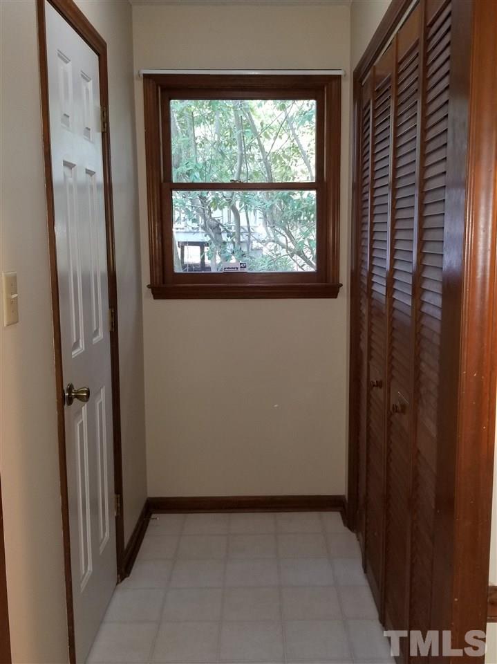 4524 Draper Road Raleigh, NC 27616 - Photo 7 of 20 a view of a hallway with wooden shelves