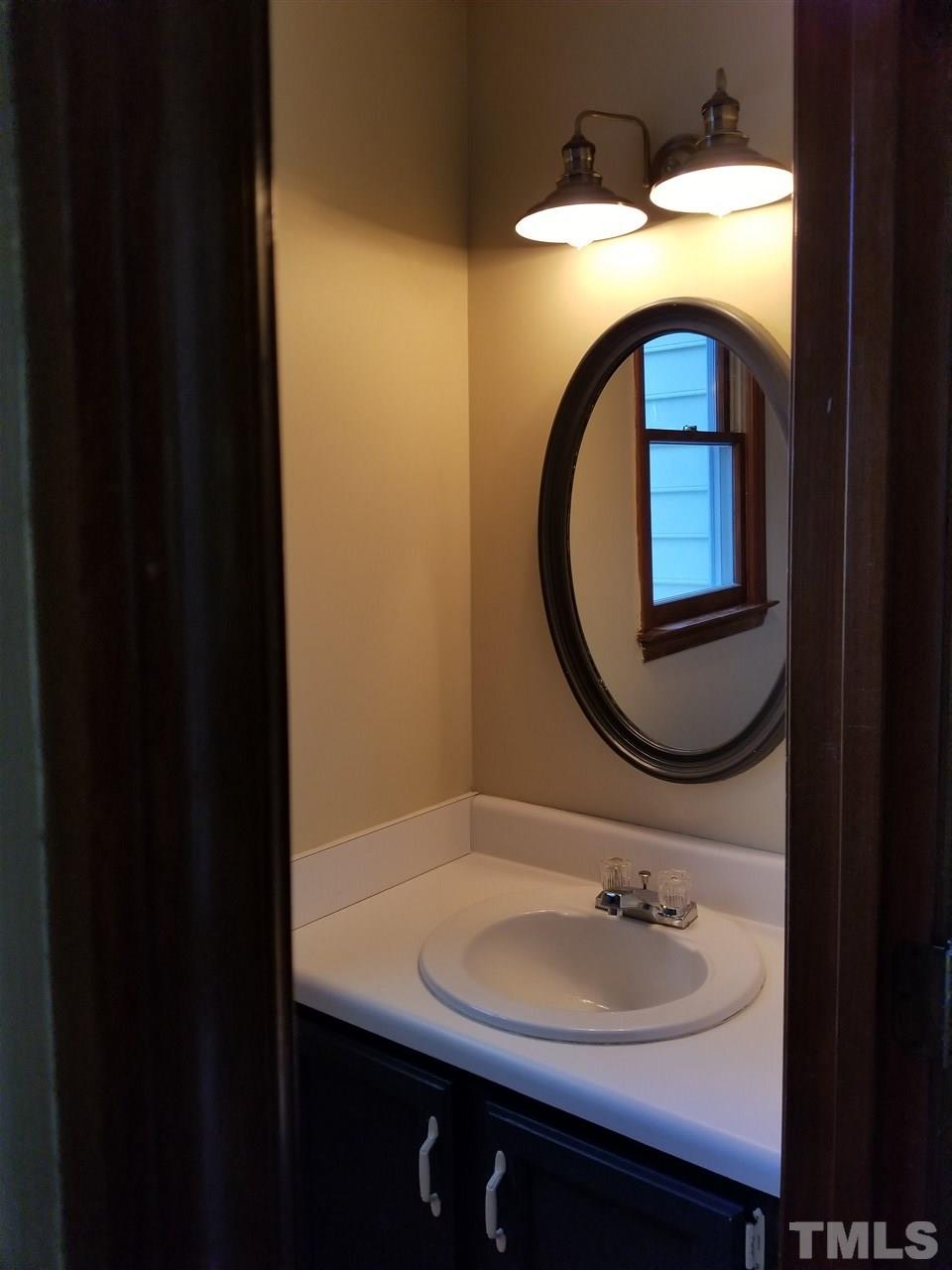 4524 Draper Road Raleigh, NC 27616 - Photo 8 of 20 a bathroom with a sink and a mirror
