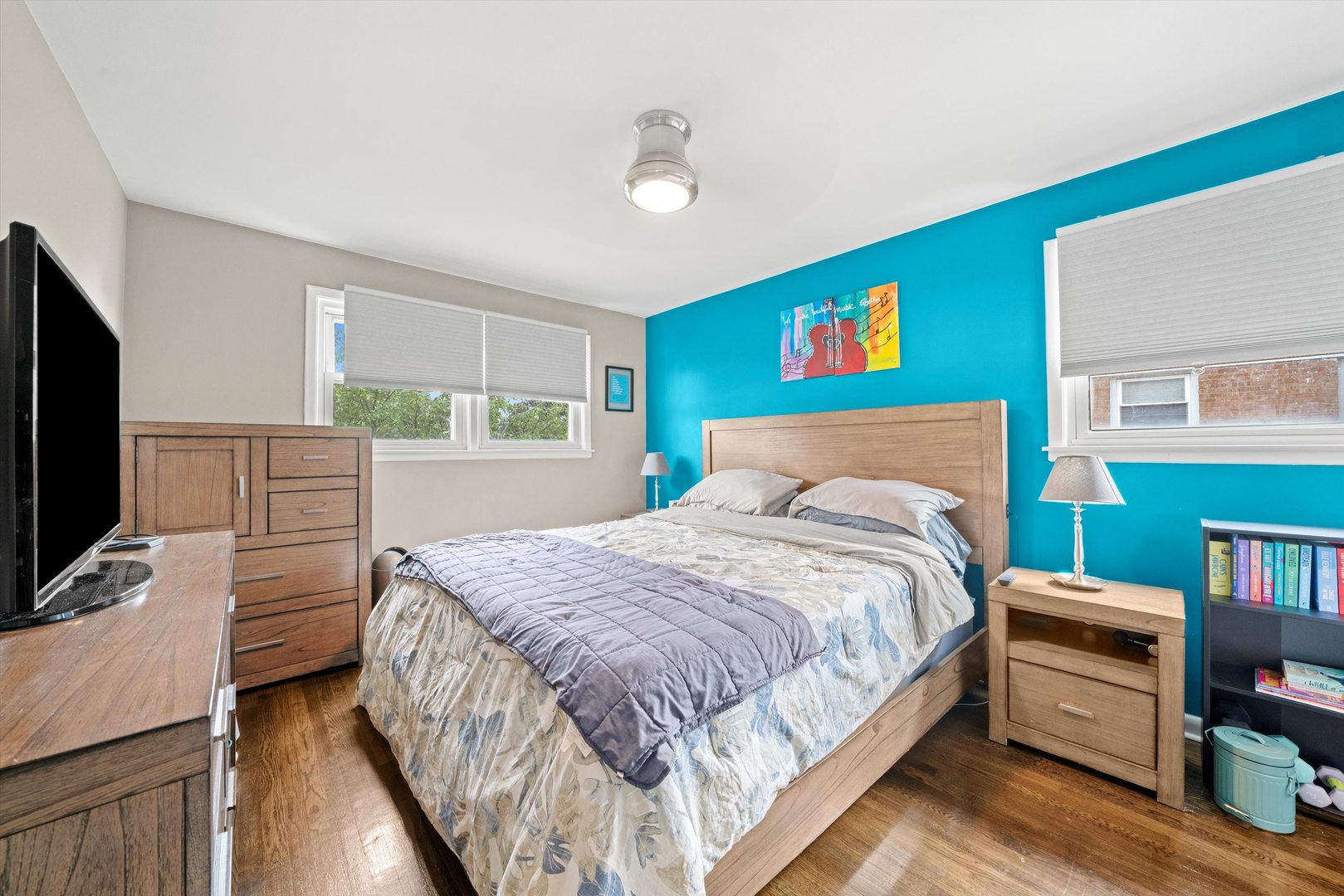 8819 North Wisner Street, Unit 2 Niles, IL 60714 - Photo 12 of 22 a bedroom with a bed and a flat screen tv