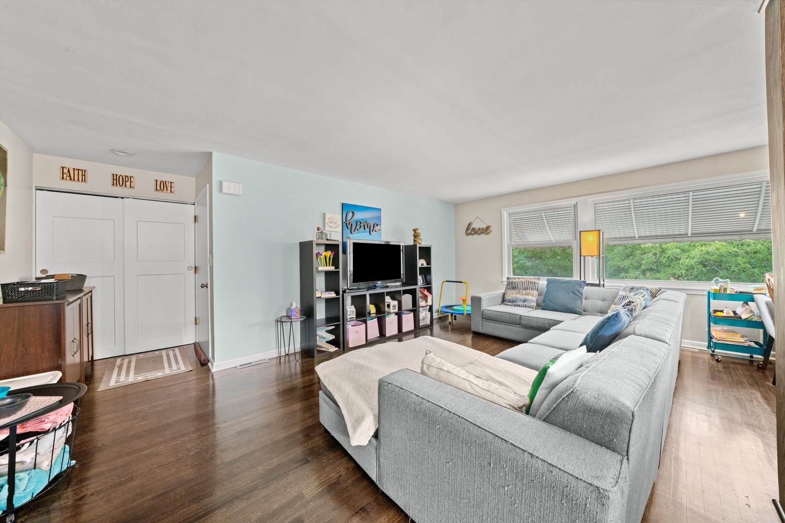 8819 North Wisner Street, Unit 2 Niles, IL 60714 - Photo 5 of 22 a living room with furniture a flat screen tv and a refrigerator