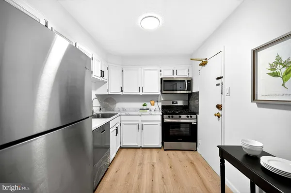 a kitchen with stainless steel appliances a refrigerator sink and stove