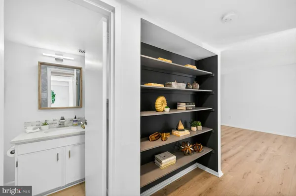 a bathroom with a double vanity sink and cabinets