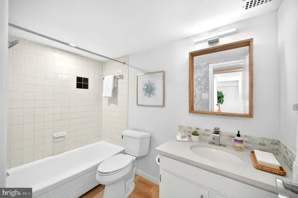 a bathroom with a sink toilet and mirror