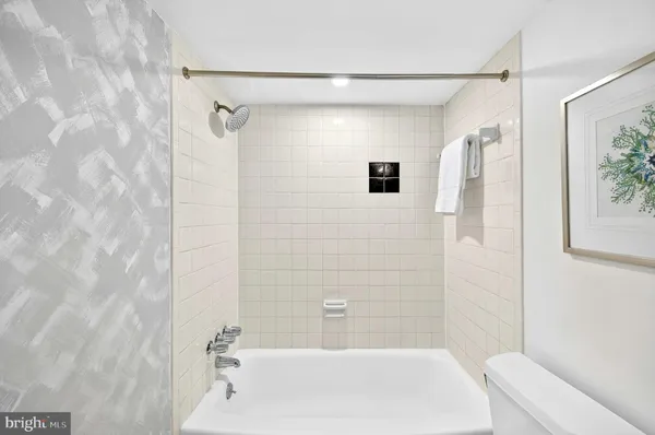 a bathroom with a shower and a bath tub