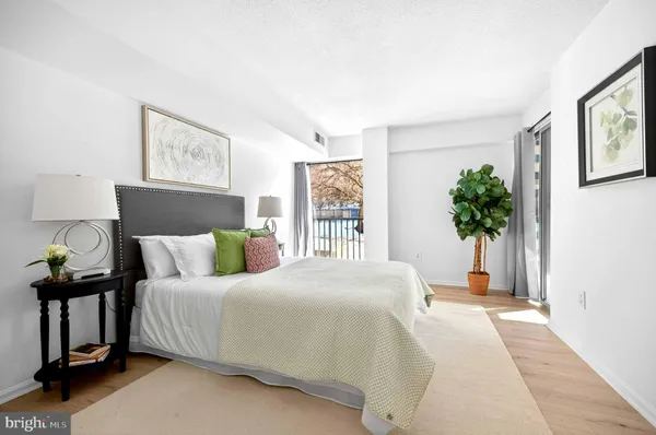 a bedroom with a bed and a potted plant